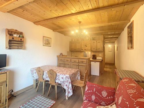 une cuisine et une salle à manger avec une table et des chaises dans l'établissement Studio cosy avec cabine, pied des pistes à Combloux, balcon, casier à skis, équipements modernes - FR-1-560-56, à Combloux