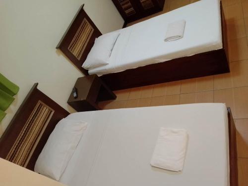 a bedroom with two bunk beds with white sheets at Darunday Manor in Tagbilaran City