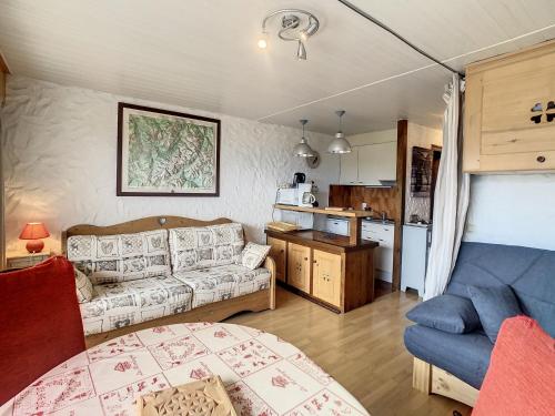 a living room with a couch and a kitchen at Charmant studio près du centre de Combloux avec kitchenette - FR-1-560-54 in Combloux