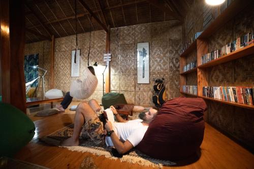dos personas en el suelo en una sala de estar en Nautilus Hostel & Hammocks, en Panglao