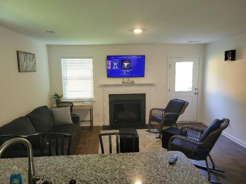 a living room with a couch and a fireplace at SC 3755 New 2 bedroom Townhouse Ft Jackson & USC in Columbia