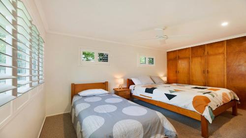 a bedroom with two beds and a window at 20 Mackay St Dicky Beach QLD in Caloundra