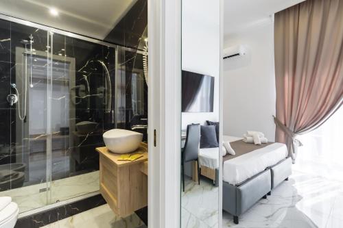 a bathroom with a shower and a sink and a toilet at Hotel Sant'Angelo Palace in Naples