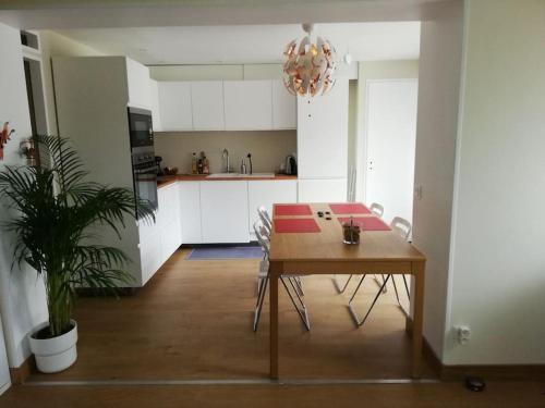 a kitchen with a wooden table and a dining room at Balcons du Royans.Logement entier Piscine in Saint-Jean-en-Royans