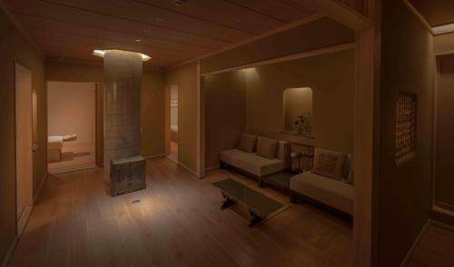 a living room with a couch and a fireplace at Gora Kadan in Hakone