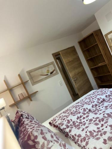 a bedroom with a bed and a wooden door at AmStein in Kaltenbach