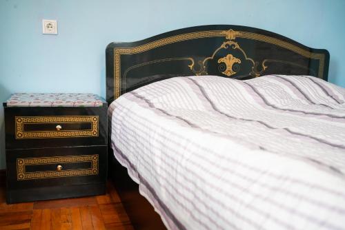 a bedroom with a bed with two night stands next to it at Marina kvariati in Kvariati