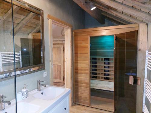 a bathroom with a sink and a glass shower at Refuge des Sottais in Burg-Reuland