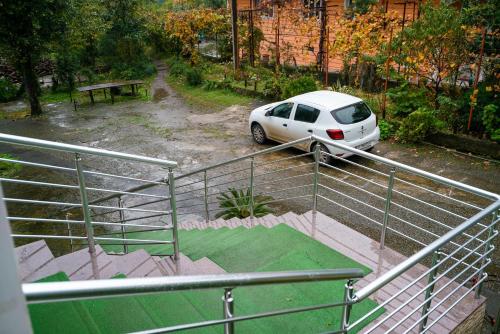 a white car parked in a parking lot at Marina kvariati in Kvariati
