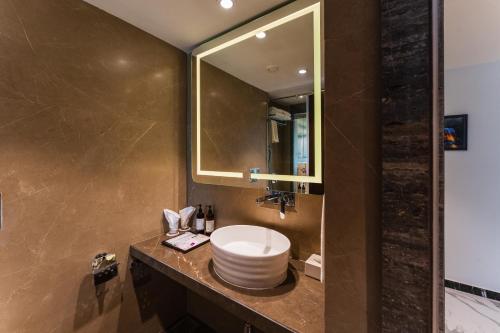 a bathroom with a sink and a mirror at Regenta Central Imperial Candolim Goa in Candolim