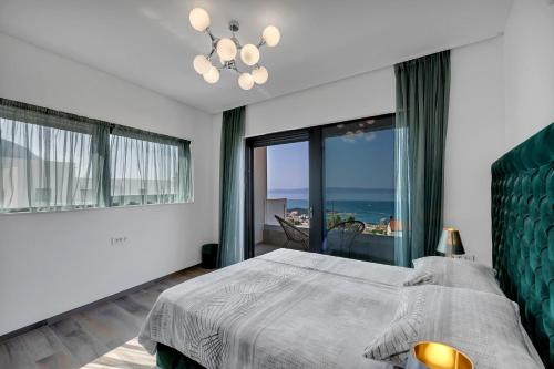 a bedroom with a bed with a view of the ocean at Villa Nina 2, Makarska in Makarska