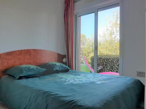 a bedroom with a bed and a large window at Appartement Ciboure, 2 pièces, 4 personnes - FR-1-239-511 in Ciboure
