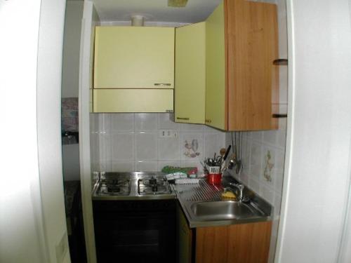 a small kitchen with a sink and a stove at Chiaia Apartments by Caseaponza it in Ponza