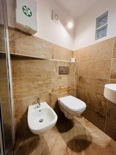 a bathroom with a toilet and a sink at BelSorrisoVarese - Elegance City Residence Private Parking -Reservation Required- in Varese
