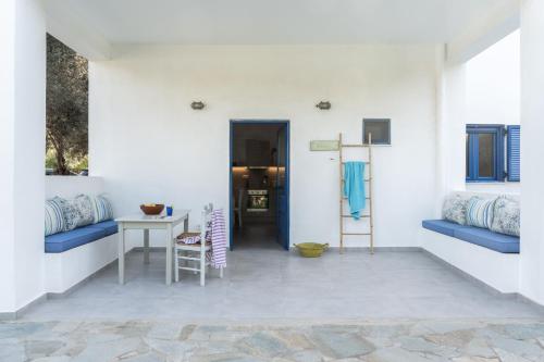 a hallway with a table and chairs in a house at Alasthas in Gavrion