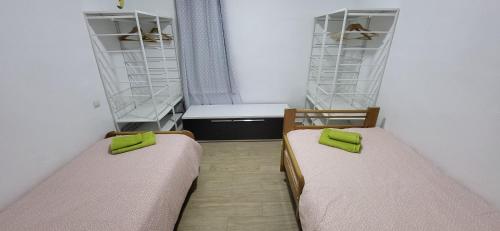 a small room with two beds and a desk at Costa de Granada Calle peatonal in Salobreña