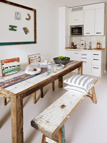 a kitchen with a wooden table and benches at VISIONAPARTMENTS Berlin - contactless check-in in Berlin