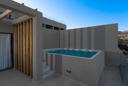 a swimming pool on the side of a house at Meliti Hotel (Adults Only) in Agios Nikolaos