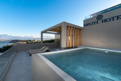 a swimming pool on the roof of a house at Meliti Hotel (Adults Only) in Agios Nikolaos