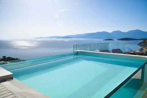 a swimming pool with a view of the water at Meliti Hotel (Adults Only) in Agios Nikolaos