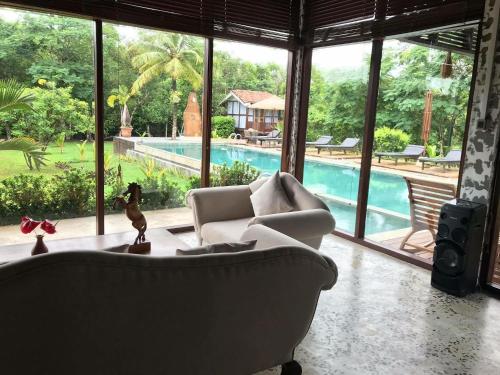 a living room with a couch and a pool at OHEI in Tangalle
