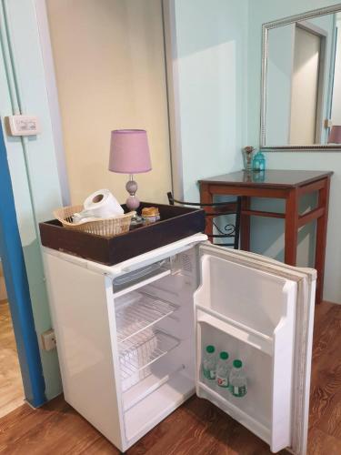 a white refrigerator with its door open in a room at Klai Hat Inn in Hua Hin