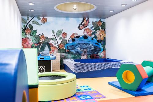 a childs room with a mural on the wall at Hotel Krone - Aktiv & Erholt in Churwalden