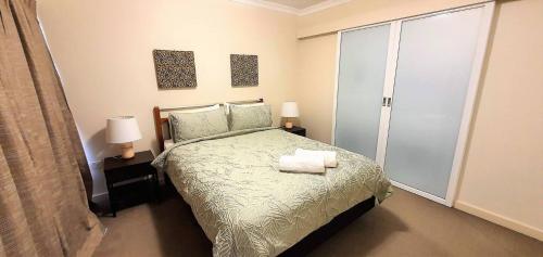 a bedroom with a bed with two towels on it at Heart of the City 504 in Perth