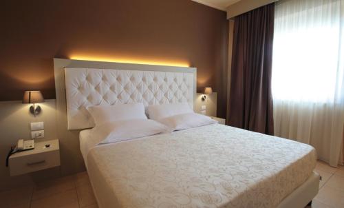 a bedroom with a large bed and a window at Mediterranean Boutique Hotel in Tropea