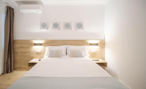 Postel nebo postele na pokoji v ubytování Hostal Menurka
