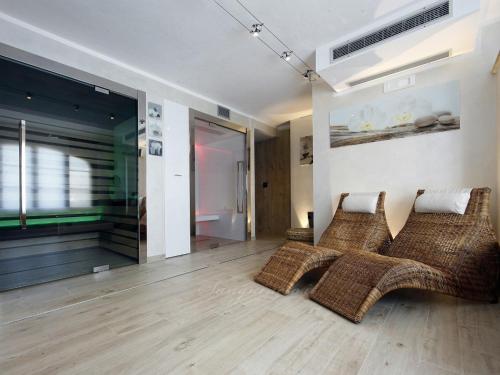 a living room with two wicker couches on the floor at Agriturismo Sanguineto in Acquaviva