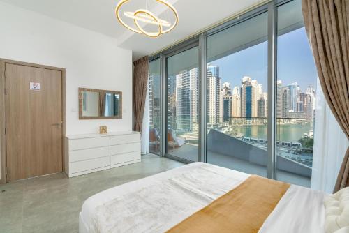 um quarto com uma cama e uma grande janela em Vacay Lettings - Waterfront Luxury home with full Marina view em Dubai
