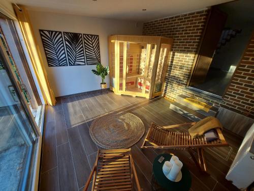 an overhead view of a living room with a table and bench at L'Éphém'Heer in Hastière-par-delà