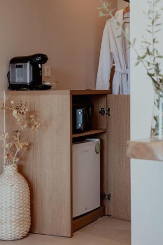 a room with a counter with a microwave and a washing machine at Meliti Hotel (Adults Only) in Agios Nikolaos