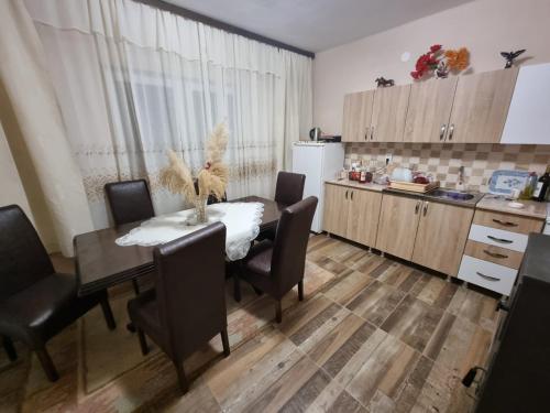 a kitchen with a table and chairs and a kitchen with a refrigerator at Hacijenda Milosavljević in Vrnjačka Banja