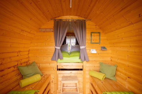 a small room in a wooden cabin with a window at Metzenhof in Kronstorf