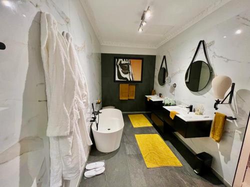 a bathroom with a sink and two sinks and a toilet at Forty 4 On Hoog in Polokwane