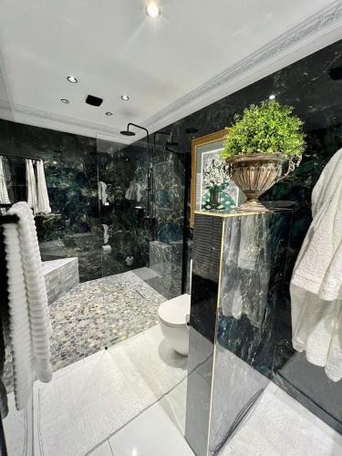 a bathroom with a shower and a toilet and a tub at Forty 4 On Hoog in Polokwane