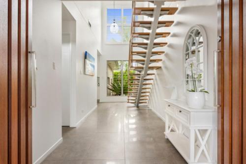 a hallway with a staircase in a house at Key Ct 10 in Noosa Heads