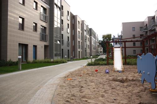 an empty street with a playground in front of buildings at Sopocka Bryza in Sopot