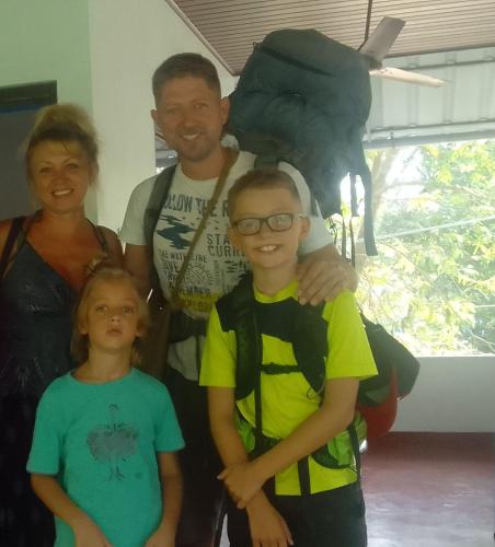 a man and his family posing for a picture at Marari diya homestay in Mararikulam