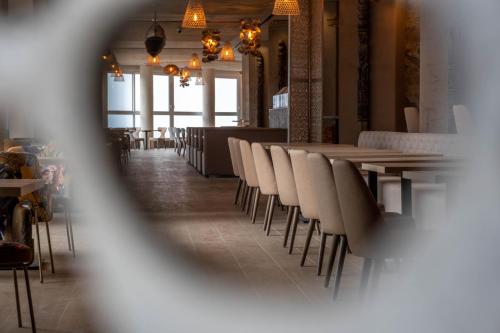 a row of tables and chairs in a restaurant at Cádiz Bahía by QHotels in Cádiz