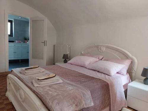a bedroom with a large bed with two towels on it at Albero della vita in Cuneo