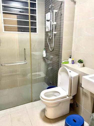 a bathroom with a toilet and a glass shower at Homestay 3BR near Setia Alam in Shah Alam