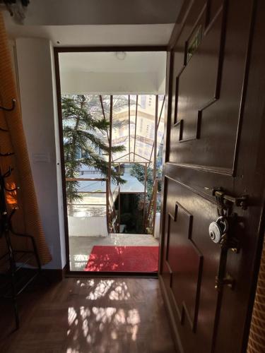 an open door to a room with a red rug at Sudha’s Garden Home in Kathmandu