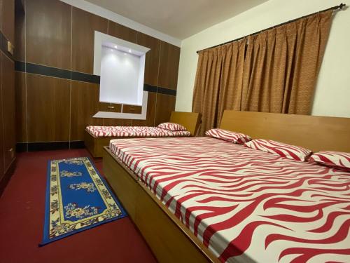 a hotel room with two beds and a window at Sudha’s Garden Home in Kathmandu