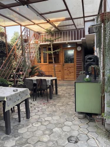 an outdoor patio with tables and chairs and a building at Sudha’s Garden Home in Kathmandu