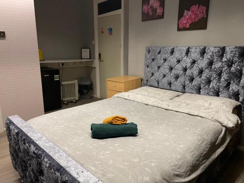 a bed with a stuffed animal on top of it at Bright Apartments in Peterborough