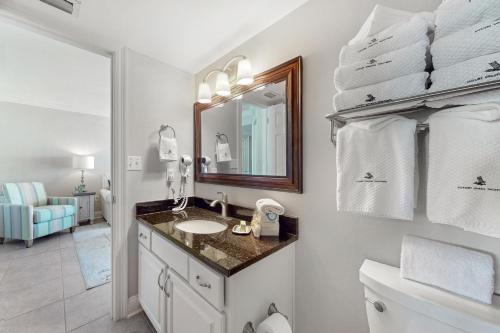 a bathroom with a sink and a mirror at Phoenix Vll 1002 in Orange Beach