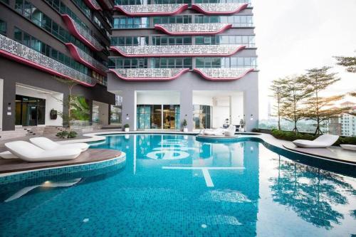 a swimming pool in front of a building at Cozy 2BR APT @Ampang Embassy Row in Kuala Lumpur